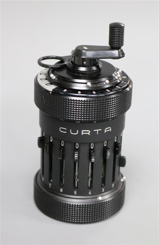 A Curta cylindrical mechanical calculator, circa 1950, in black plastic canister